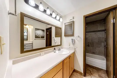 a bathroom with a sink and a mirror at Flying Dutchman 1202 in Keystone