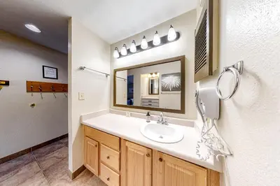a bathroom with a sink and a mirror at Flying Dutchman 1202 in Keystone