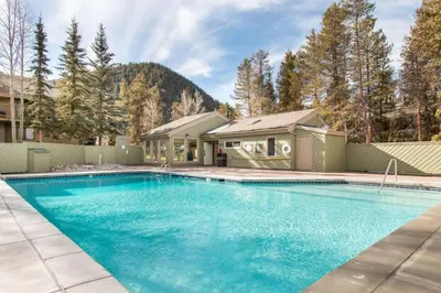 a swimming pool in front of a house at Flying Dutchman 1202 in Keystone