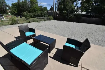 a couple of chairs and a table on a patio at Wild West-Inspired Family Home in Denver