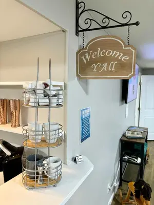 a welcome sign is hanging above a shelf with dishes at Wild West-Inspired Family Home in Denver