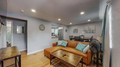 a living room with a couch and a table at Unique Family Home in Denver in Denver