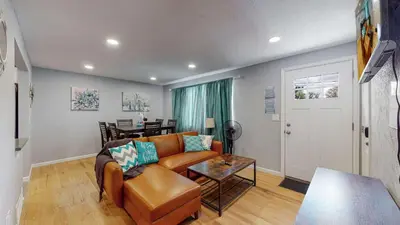 a living room with a couch and a table at Unique Family Home in Denver in Denver