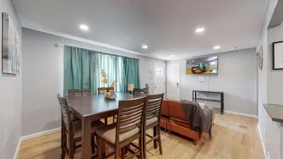 a dining room and living room with a table and chairs at Unique Family Home in Denver in Denver
