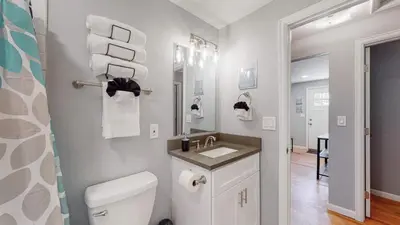 a bathroom with a white toilet and a sink at Unique Family Home in Denver in Denver