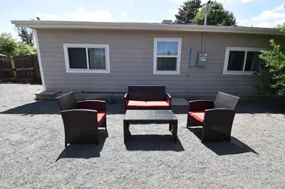 a group of chairs and a table in front of a house at Unique Family Home in Denver in Denver