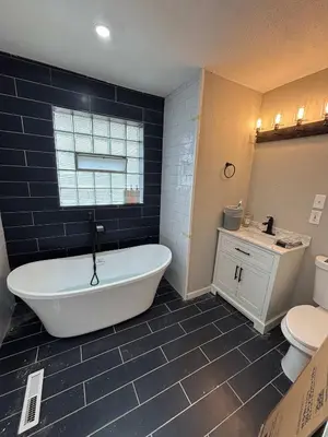 a bathroom with a tub and a toilet and a sink at Entire Family Home in Denver in Denver