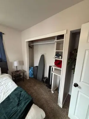 a bedroom with a bed and a closet at Entire Family Home in Denver in Denver