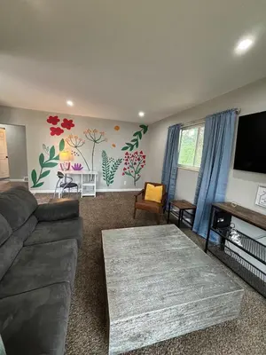 a living room with a couch and a flat screen tv at Entire Family Home in Denver in Denver