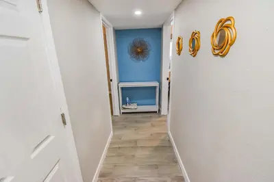 a hallway with a blue wall and a white door at Entire Family Home in Denver in Denver