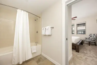 a white bathroom with a shower and a tub at Premium Unit 4663 - One Bedroom withFull Kitchen - Fraser Crossing Founders Pointe condo in Winter Park