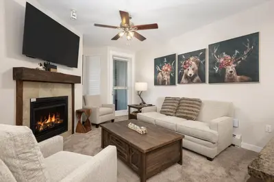 a living room with a fireplace and a flat screen tv at Premium Unit 4663 - One Bedroom withFull Kitchen - Fraser Crossing Founders Pointe condo in Winter Park
