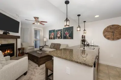 a kitchen and living room with a fireplace at Premium Unit 4663 - One Bedroom withFull Kitchen - Fraser Crossing Founders Pointe condo in Winter Park