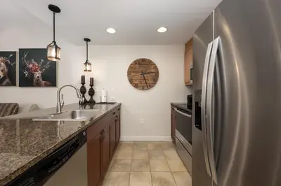 a kitchen with a stainless steel refrigerator at Premium Unit 4663 - One Bedroom withFull Kitchen - Fraser Crossing Founders Pointe condo in Winter Park