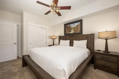 a bedroom with a bed and a ceiling fan at Premium Unit 4663 - One Bedroom withFull Kitchen - Fraser Crossing Founders Pointe condo in Winter Park