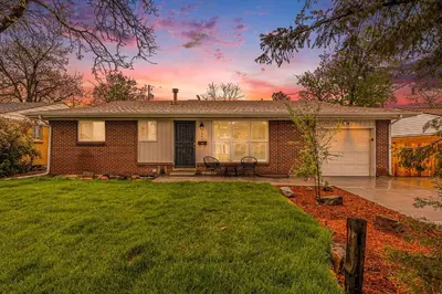 a house with a grass yard and a house at Mile Hi Basecamp Hot tub and Game Room in Denver