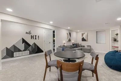 a living room with a table and a couch at Mile Hi Basecamp Hot tub and Game Room in Denver