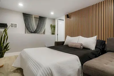 a bedroom with a large bed and a couch at Good Vibe Tribe-2 Mi DT-Hot Tub-K Bed-Pet Friendly in Denver