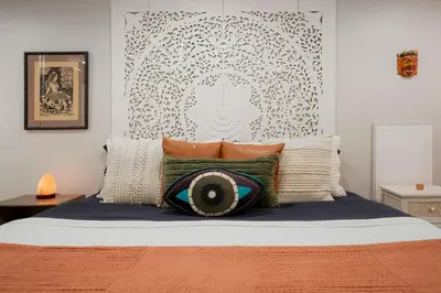 a bedroom with a bed with pillows on it at Good Vibe Tribe-2 Mi DT-Hot Tub-K Bed-Pet Friendly in Denver