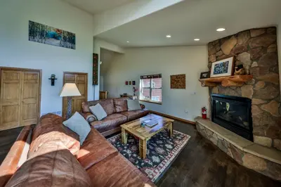 a living room with a couch and a fireplace at Mountain Bliss 3 BR Retreat With Views and Hot Tub in Tabernash