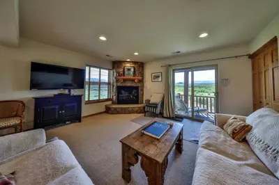 a living room with a couch and a table at Mountain Bliss 3 BR Retreat With Views and Hot Tub in Tabernash
