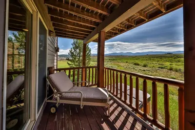a rocking chair on a porch with a view at Mountain Bliss 3 BR Retreat With Views and Hot Tub in Tabernash