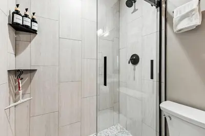 a shower with a glass door in a bathroom at Meadow Creek Retreat Near Trails and Downtown in Frisco