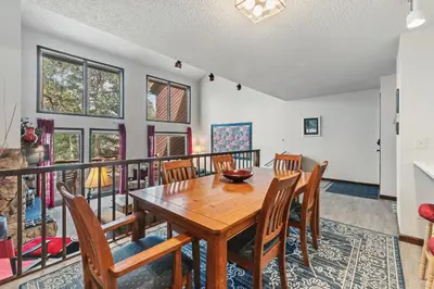 a dining room with a wooden table and chairs at Meadow Creek Retreat Near Trails and Downtown in Frisco