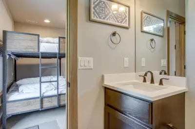 a bathroom with a sink and a bunk bed at 2 Mi to Fraser River Trail Townhome with Hot Tub! in Fraser