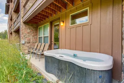 a bath tub on the side of a house at 2 Mi to Fraser River Trail Townhome with Hot Tub! in Fraser