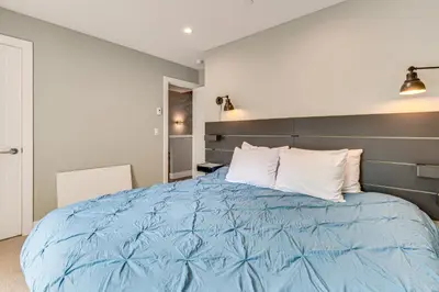 a bedroom with a blue bed with white pillows at Ski-InandSki-Out Gemini Lift Access! Home with Hot Tub in Winter Park