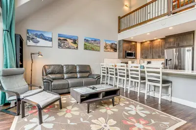 a living room with a couch and a table at Ski-InandSki-Out Gemini Lift Access! Home with Hot Tub in Winter Park
