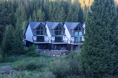 a large house in the middle of a forest at Ski-InandSki-Out Gemini Lift Access! Home with Hot Tub in Winter Park