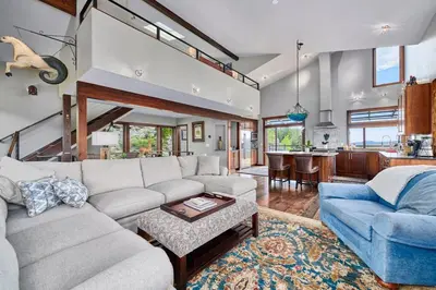 a living room with a couch and a table at Rancho la Chula - Gambling Golf Hiking Hot Tub! in Black Hawk