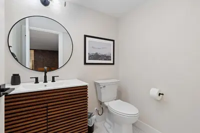 a bathroom with a toilet and a mirror at Denver 5BR Hot Tub, Pool Table, Ping Pong! in Denver