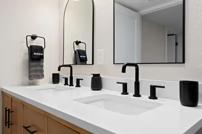 a bathroom with two sinks and a large mirror at Denver 5BR Hot Tub, Pool Table, Ping Pong! in Denver