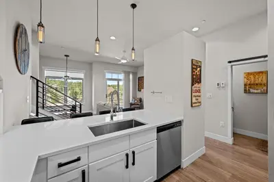 a kitchen with white cabinets and a sink at 78311 US HWY 40 Unit 6 in Winter Park