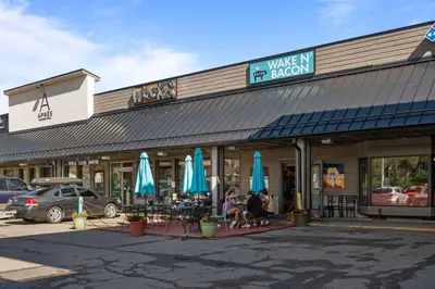 a building with umbrellas and people sitting outside of it at 78311 US HWY 40 Unit 6 in Winter Park
