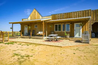 a wooden house with a picnic table in front of it at Yak Ranch with Mountain Views, Near Wellington!