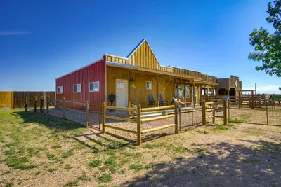 a barn with a fence in front of it at Yak Ranch with Mountain Views, Near Wellington!