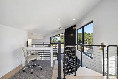 a home office with a desk and a balcony at Modern Mtn Escape! Hot Tub Fireplace Views! in Bailey