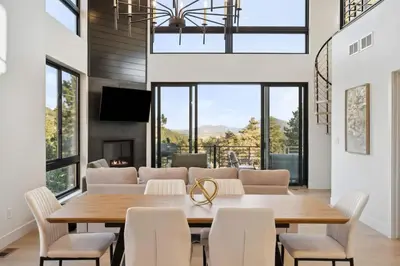 a dining room with a table and chairs at Modern Mtn Escape! Hot Tub Fireplace Views! in Bailey