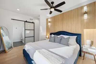 a bedroom with a large bed with a ceiling fan at Modern Mtn Escape! Hot Tub Fireplace Views! in Bailey