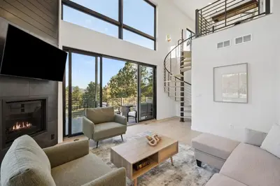 a living room with a fireplace and a tv at Modern Mtn Escape! Hot Tub Fireplace Views! in Bailey