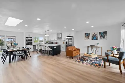 a kitchen and living room with a table and chairs at Lake Arbor Family Retreat with Backyard Oasis in Arvada