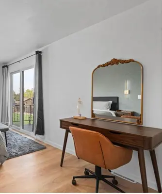 a bedroom with a desk with a mirror and a bed at Lake Arbor Family Retreat with Backyard Oasis in Arvada