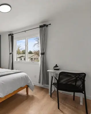 a bedroom with a bed and a chair and a window at Lake Arbor Family Retreat with Backyard Oasis in Arvada