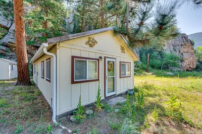 a tiny house in the middle of a field at Hike, Fish and Relax Cabin 4 Mi to Lake Estes! in Drake