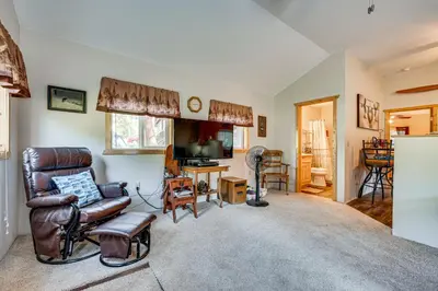 a living room with a couch and a chair at Hike, Fish and Relax Cabin 4 Mi to Lake Estes! in Drake
