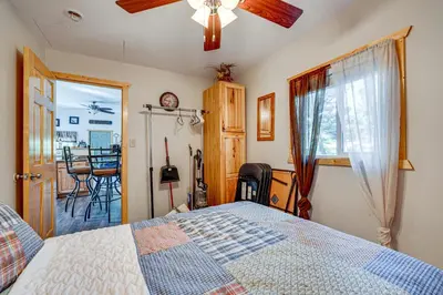a bedroom with a bed and a dining room at Hike, Fish and Relax Cabin 4 Mi to Lake Estes! in Drake